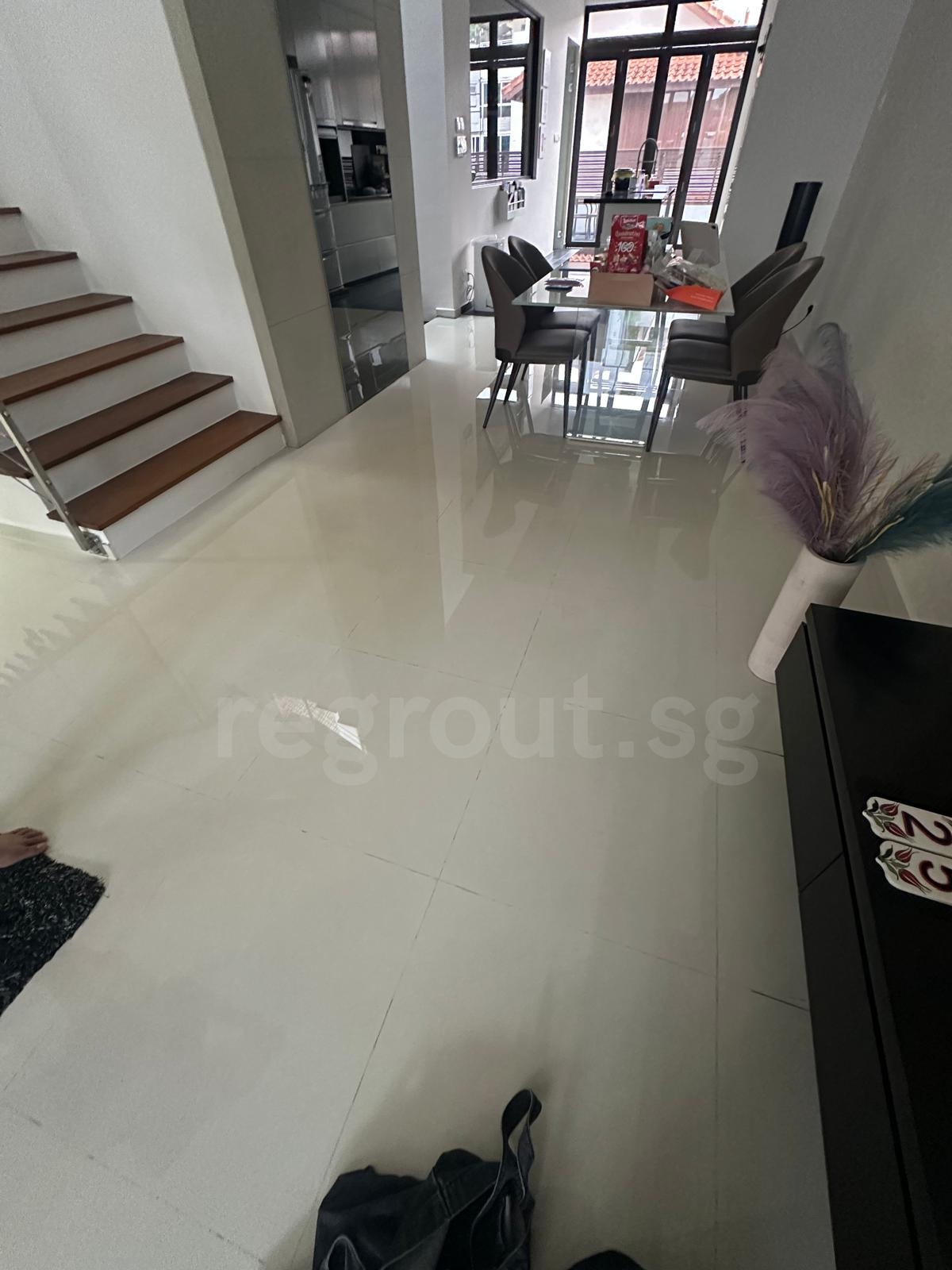 Polyurea grouting applied on bathroom floor tiles for clean white grout lines in Singapore home