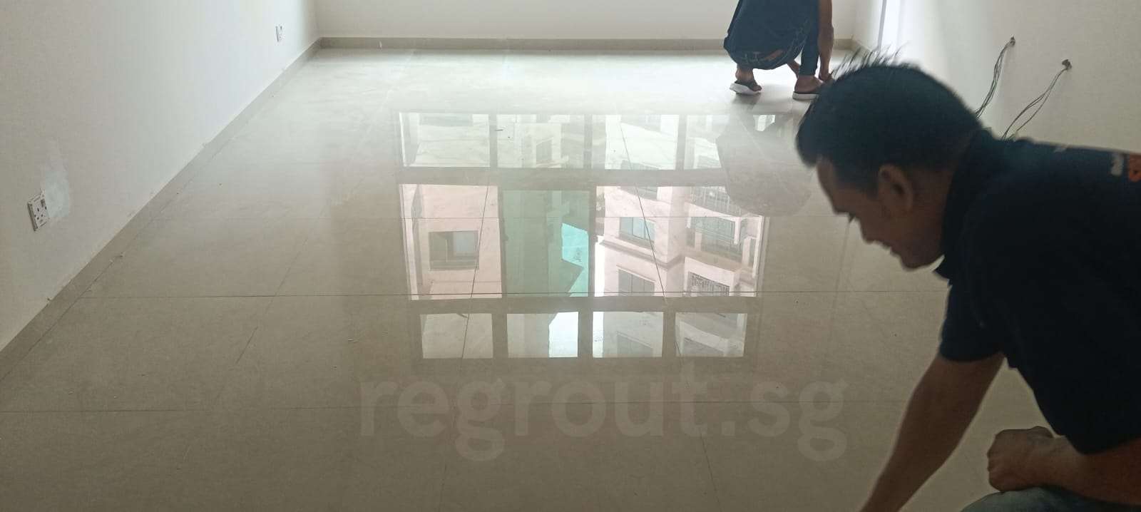 Polyurea grouting applied on bathroom floor tiles for clean white grout lines in Singapore home